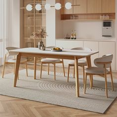 a dining room table and chairs in front of an open kitchen area with wooden cabinets