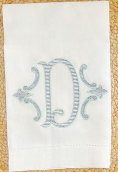 an embroidered monogrammed napkin with the letter d on it