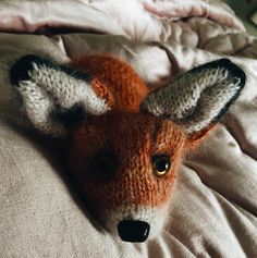 a stuffed animal laying on top of a bed