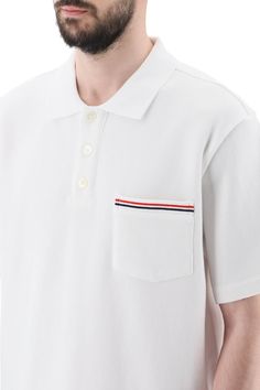 Thom Browne polo shirt crafted in solid pure cotton jersey. Design with spread collar and three-button half placket featuring a chest patch pocket decorated with tricolor band, dropped back hem with buttoned slits finished with tricolor grosgrain. Embellished with tricolor loop tab on the upper-back. Relaxed fit. The model is 187 cm tall and wears size 3 Thom Browne. Size Info MONCLER Color Detail White Made In Japan Material 100% CO Season One spring Season Two summer Product clothing Brand Tho Classic Polo T-shirt With Striped Collar, Classic Polo Shirt With Contrast Stripes, Classic Polo Shirt With Striped Johnny Collar, Classic Polo Collar T-shirt With Button-up, Classic Polo Collar T-shirt With Button Closure, Classic Collared Polo Sweater With Contrast Stripes, White Polo Shirt With Ribbed Collar For Work, Short Sleeve Polo Shirt With Contrast Stripes For Workwear, Casual Cotton Polo Sweater With Contrast Stripes