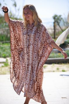 "This Oversize kaftan dress is the best choice for the summer and can be transformed for any occasion from casual to Special Occasion, day-to-night. The Dress is made of rayon, which is very lightweight and flowy.  It has lots of style and presence and feels so cool and chic. It is guaranteed to turn heads around... :) Fits all sizes - up to XXL and looks great on any body type. The Dress has pockets, and buttons, and is made of Rayon. COLOR - Snakeskin (Beige and Brown tones) Also Available in - 7 more prints! for example -  Blue and White Stripes - https://www.etsy.com/listing/728071093/ Brown Leopard Print - https://www.etsy.com/listing/728070405/ SIZE: Available in One Size - Up to 48.5\" (123 cm) bust and hips. Length - front 49.5\" (126 cm), back 54\" (138 cm) ⊱I ship your item/s wit Brown Long Maxi Dress For Beach Cover-up, Long Brown Kaftan For Summer, Long Brown Summer Kaftan, Summer Brown Kaftan For Beach Cover-up, Summer Beach Cover-up Brown Kaftan, Brown Long Kaftan For Beach Cover-up, Summer Brown Kaftan For Beach, Oversized Short Sleeve Kaftan For Festivals, Festival Oversized Short Sleeve Kaftan