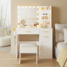 a white vanity with lights on it next to a bed and chair in a room