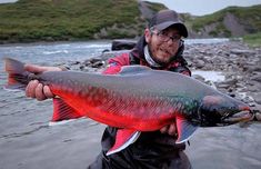 a man holding a large fish in his hands