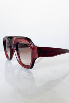 Sasha X Sunglasses in Rubi from Lapima Bold, oversized, and modern aviator design Frames: Translucent deep red Italian acetate frames Brown gradient lenses 100% UV protection Hand crafted in Brazil Measurements: Temple length - 150 mm Lens width - 48 mm Nose bridge length - 24 mm Total width - 150 mm Total height - 61 mm Modern Red Shield Sunglasses With Gradient Lenses, Red Acetate Sunglasses With Gradient Lenses, Red Acetate Sunglasses With Polarized Lenses, Modern Red Aviator Sunglasses With Mirrored Lenses, Modern Red Aviator Sunglasses With Gradient Lenses, Modern Red Aviator Sunglasses With Uva Protection, Modern Red Aviator Sunglasses With Uv Protection, Swim Jewelry, Back Jewelry