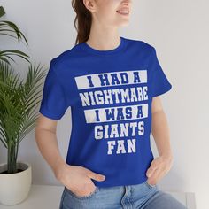 a woman wearing a blue t - shirt that says i had a nightmares i was a giants fan