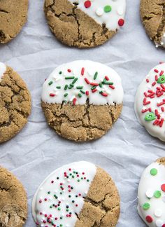 several cookies with white frosting and sprinkles