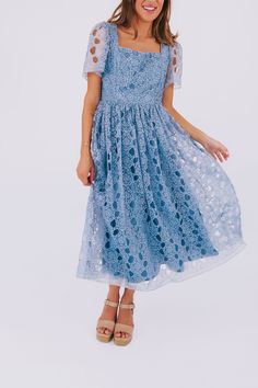 Elevate your style with our EXCLUSIVE Seaside Brunch Dress. In a beautiful dusty blue, our midi dress features a delicate floral eyelet overlay and a double tie for a touch of elegance. The square neck adds a unique touch to this one-of-a-kind design, exclusively available at One Loved Babe. Available in sizes XS-6XL for all to enjoy. Details Midi length Sheer sleeves Lined Invisible zipper enclosure Double tie Square neck Floral eyelet overlay Sizing *Measurements are taken with item hanging an Spring Lace Midi Dress With Short Sleeves, Light Blue Lace Midi Dress Knee-length, Spring Party Light Blue Lace Dress, Light Blue Lace Midi Dress For Summer, Blue Lace Midi Dress For Summer, Light Blue Lace Midi Dress For Spring, Modest Blue Midi Dress For Garden Party, Elegant Dusty Blue Spring Dress, Blue Lace Spring Dress