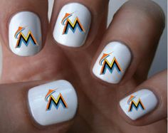 the manies are white with an orange and blue m design on each nail tip