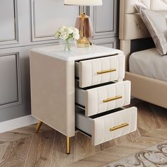 a nightstand with three drawers and a lamp