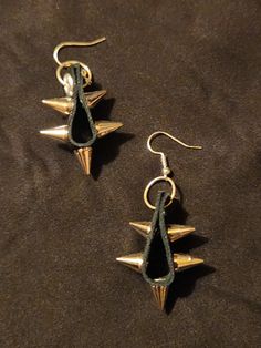 Black leather with spikes and rivers.  5 spikes on each earring, set of two earrings.  Each measures 2.5 inches long.  One of a kind and unique, ready to ship. To continue shopping: http://www.rrrobinnn.etsy.com Gothic Leather Earrings, Black Spiked Jewelry For Festival, Black Spiked Jewelry For Concerts, Edgy Spiked Jewelry For Festivals, Edgy Spiked Jewelry For Concerts, Edgy Festival Jewelry With Spikes, Edgy Metal Plug Earrings, Edgy Leather Jewelry With Studs, Edgy Dangle Plug Earrings