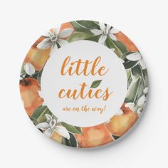 a plate with the words little cutie written in orange and green leaves on it