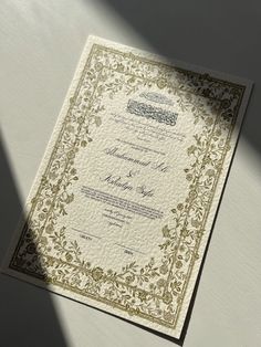 an ornate wedding card on a table