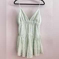 Hey Babe, Meet The Delilah Floral Romper! This Adorable Piece Is Complete With A V-Neckline, Pleated Detailing, An Airy Chiffon Material, A Ditzy Floral Print, And A Flouncy Fit And Flare Design. Available In Pink And Green. Pair With The Kali Sneakers In White For A Flirty & Fun Vibe! Details 100% Polyester Back Zip Closure Built In Shorts Adjustable Spaghetti Straps Hand Wash Cold / Hang Dry Cute Green Jumpsuits And Rompers For Spring, Green Jumpsuits And Rompers For Spring Brunch, Spring Brunch Green Jumpsuits And Rompers, Hey Babe, American Threads, Chiffon Material, Floral Romper, Fit And Flare, Pink And Green