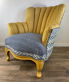 a blue and yellow chair sitting on top of a hard wood floor