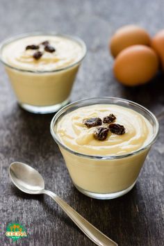 two small bowls filled with pudding next to eggs