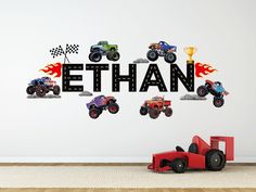 a child's room with a wall decal that says ethan and monster trucks