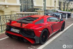 a red and black sports car parked on the street