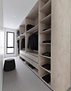 an empty walk in closet with clothes on shelves