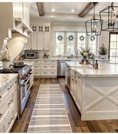 the kitchen is clean and ready to be used for cooking or baking, with white cabinets and wood flooring