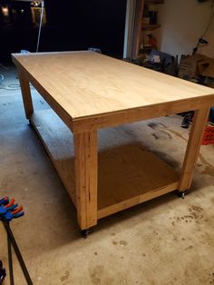 a workbench in a garage with tools on the floor