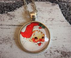 "Christmas pendant necklace featuring a a super sweet Santa Clause image. The image is under glass and the setting is antiqued silver-tone metal. The pendant is attached to a 24\" chain with lobster claw closure. Pendant is 25mm or about 1\" in diameter. Thank you for looking at my item!" Vintage Christmas Gift Necklaces, Vintage Necklaces For Christmas Gifts, Vintage Necklace For Christmas Gift, Retro Necklaces With Lobster Clasp For Gifts, Retro Necklaces With Lobster Clasp As A Gift, Retro Necklace With Lobster Clasp As Gift, Retro Nickel-free Necklaces For Gifts, Retro Nickel-free Necklace For Gift, Retro Nickel Free Necklace For Gift