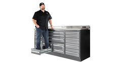 a man standing next to a tool cabinet