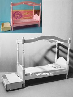 a doll bed with a pink canopy and white sheets on the bottom, in front of a blue background