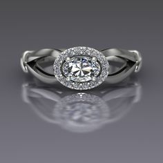 "An oval cut diamond is sideways set and surrounded by a halo of diamonds in this 14k white gold ring. Diamond is the April birthstone and has been given as an engagement ring for centuries. This petite east-west set ring measures about 7mm at the widest point. Oval Diamond Dimensions6x4mm (approx.) Carat Weight .37(approx.) EnhancementNatural ColorF-G ClaritySI1 CutVery Good PolishVery Good Diamonds Number16 EnhancementNatural Carat Total Weight0.12 ColorG-H ClaritySI2-I1 CutVery Good PolishVer Oval Halo Ring In Diamond White, Oval Diamond White Halo Ring, Oval Halo Ring With Diamond Accents In Platinum, Oval Halo Ring In Platinum With Diamond Accents, Oval Platinum Halo Ring With Diamond Accents, Oval Diamond White Halo Ring With Rose Cut Diamonds, Oval Diamond White Ring With Halo, White Oval Halo Ring With Rose Cut Diamonds, Oval Halo Ring With Rose Cut Diamonds For Promise