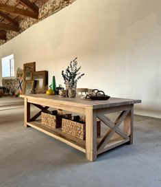 a wooden table with baskets on it in a room