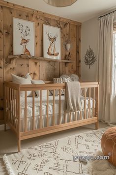 a baby's room with wood paneled walls and deer artwork on the wall