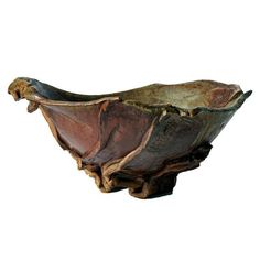 a large metal bowl sitting on top of a wooden stand