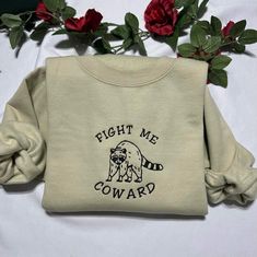 Ready to show everyone your fun side? With this Fight me Coward Funny sweatshirt, you can do just that! It features an embroidered phrase, making it the perfect way to make a statement while still looking stylish. This sweatshirt is comfortable and made of ultra-soft fabric, so you can wear it for any occasion. Whether you're headed out for a night on the town, or just staying in and relaxing, this sweatshirt will keep you stylish and comfortable. With its unique design, this funny sweatshirt is Cute Crew Neck Shirt With Funny Print, Cool Crew Neck T-shirt With Funny Print, Cricut Sweatshirt Ideas Women, Cricut Hoodie Ideas, Crewneck Sweatshirt, Cute Crew Neck Sweatshirt With Funny Print, Funny Crew Neck Sweatshirt With Print, Funny Relaxed Fit Crew Neck Sweatshirt, Funny Gifts For Her