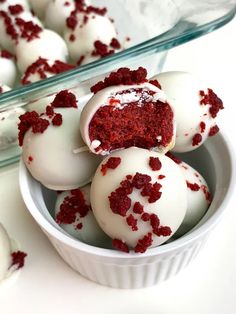 red velvet cake truffles with white frosting and sprinkles in a bowl