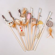 a group of different types of stuffed animals on toothpicks with wooden sticks in the middle