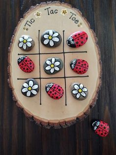 a cake decorated with ladybugs and daisies on top of a wooden board