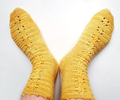 a person's feet wearing yellow knitted socks