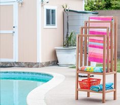 a pool with a towel rack next to it and a swimming pool in the background