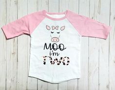 a pink and white shirt that says moo i'm two