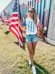 God Bless the USA Tee - MOB Fashion Boutique God Bless The Usa, Usa Tee, Fourth Of July Shirts, White Graphic Tee, Spring Vibes, 60s Fashion, Sleeve Detail, Striped Tee, Crew Neck Tee