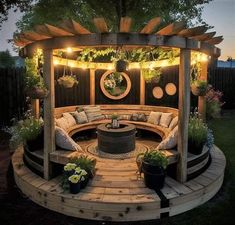 an outdoor seating area is lit up with lights