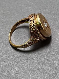 A beautiful victorian era gold ring with diamond.  6 grams 14K Gold Filigree Signet Ring with Diamond  Stamped on the inside band 14k gold A small diamond chip in the center of the signet ring with filigree. Ring is size 5 Weight: 6 grams  Marked 14 K (gold) Condition: very fine with light signs of wear from age. Please see the images for details. If you have any questions or need more images, please feel free to email me.  I am happy to send more images and answer any questions you may have. Signet Ring With Diamond, Gold Ring With Diamond, Ring With Diamond, Baltimore Md, Gold Filigree, Filigree Ring, Victorian Era, Signet Ring, Rings Statement