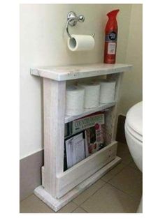 a magazine rack in the corner of a bathroom next to a toilet with a roll of toilet paper on it