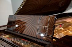 a grand piano with an art deco design on it