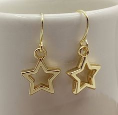 Three Pairs  Minimalist Gold Star Earrings Small Star Earrings Gold Dangle Open Star Earrings Small Gold Star Charms dangle from minimalist gold filled ear wire. Very simple, yet impactful, in design.  These Open Star Earrings are certain to become your favorite accessory. Each pair of Star Earrings will arrive in an organza pouch with a matching polishing cloth. Gift packaging and gift card cheerfully provided upon request! Hanging Star Earrings, Minimalist Gold Jewelry Earrings, Gold Star Earrings Aesthetic, Star Gold Jewelry, Gold Star Jewelry Aesthetic, Gold Star Accessories, Simple Gold Dangle Earrings, Star Earrings Gold, Dangly Gold Earrings