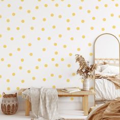 a bedroom with yellow polka dots on the wall