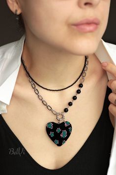 A unique necklace with a pendant - a voluminous black velvet heart. The heart is embroidered with premium quality Japanese beads. The stainless steel chain is decorated with vintage Czech beads. The clasp is on the front, so you don't have to worry about the necklace getting twisted. There is a nifty regulating chain. The back side of the heart is lined with metallic fuchsia leather. The set is complemented by a stylish minimalist necklace made of black beads. Each can be worn independently. SIZ Black Heart Pendant Chain Jewelry, Black Heart-shaped Chain Jewelry, Black Heart Pendant Necklace With Clavicle Chain, Black Heart Choker Necklace Gift, Black Heart Choker Necklace For Gift, Black Heart Pendant Necklace With Adjustable Chain, Black Chain Necklace For Valentine's Day, Gift Black Heart Choker Necklace, Black Valentine's Day Necklace