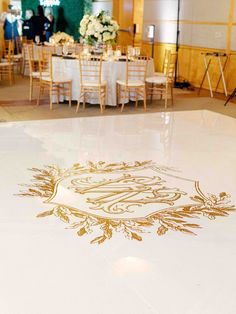 Weddingspartiesfundraising galascorporate conference events with Full ServicePartial Planningand Day of Event Coordination and Design in DallasFtWorth. White Dance Floor With Gold Monogram, Custom Dance Floor, White Vinyl Flooring, Wedding Columns, Plant Styling