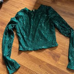 Glittery Green Top Zipper Down The Back Super Comfy Looks Like It Would Be Itchy But Isn’t At All! Size Small Never Worn Glamorous Green Top For Evening, Glamorous Green Tops For Evening, Glamorous Green Evening Tops, Green Top For Night Out Party Season, Green Tops For Evening Party Season, Festive Long Sleeve Glitter Tops, Green Sequin Tops For Fall, Green Sequined Tops For Spring, Green Fitted Glamorous Top