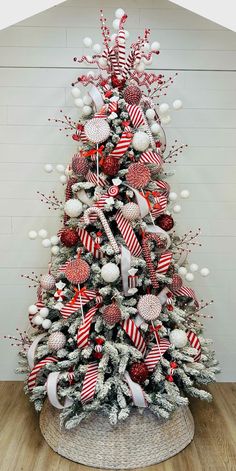 a christmas tree decorated with red, white and silver ornaments