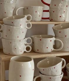 a shelf filled with lots of white cups and saucers